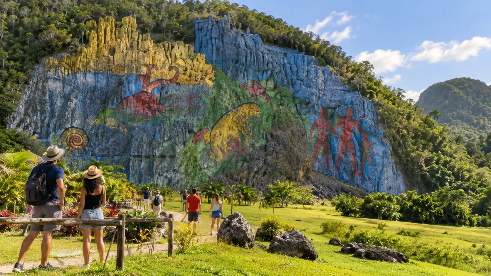 Travellers walking up to the Mural de la Prehistoria painted on a mogote