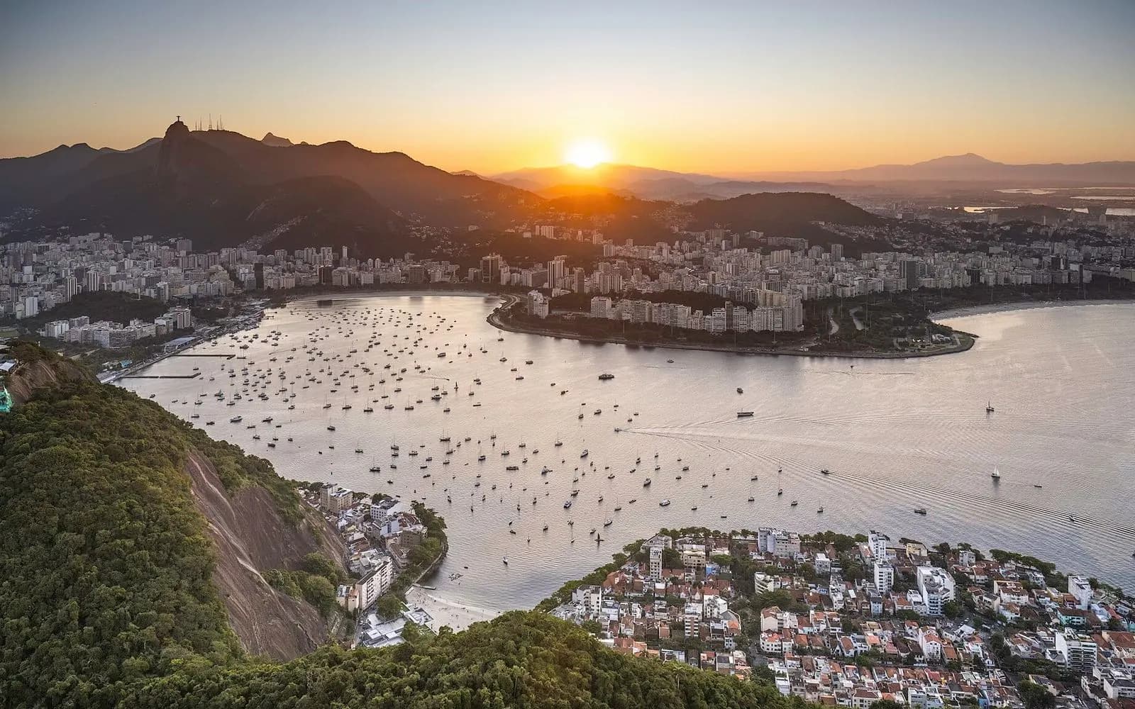 Sunset over Botafogo bay and the Rio skyline with Christ the Redeemer on distant Corcovado, Brazil