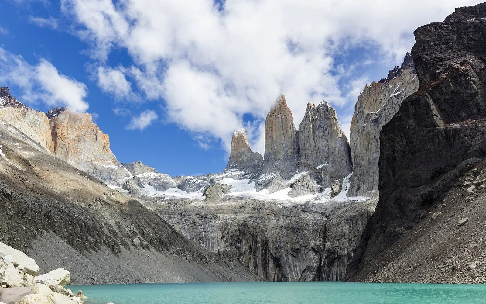 The three granite Towers of Paine above a turquoise glacial lake under blue sky, Chile