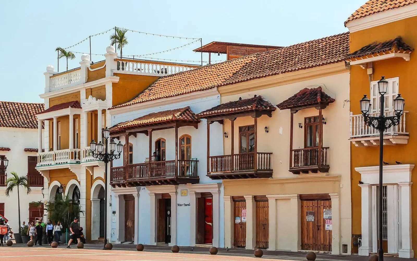 Colourful colonial buildings with wooden balconies and street lamps on Plaza de la Aduana, Cartagena, Colombia