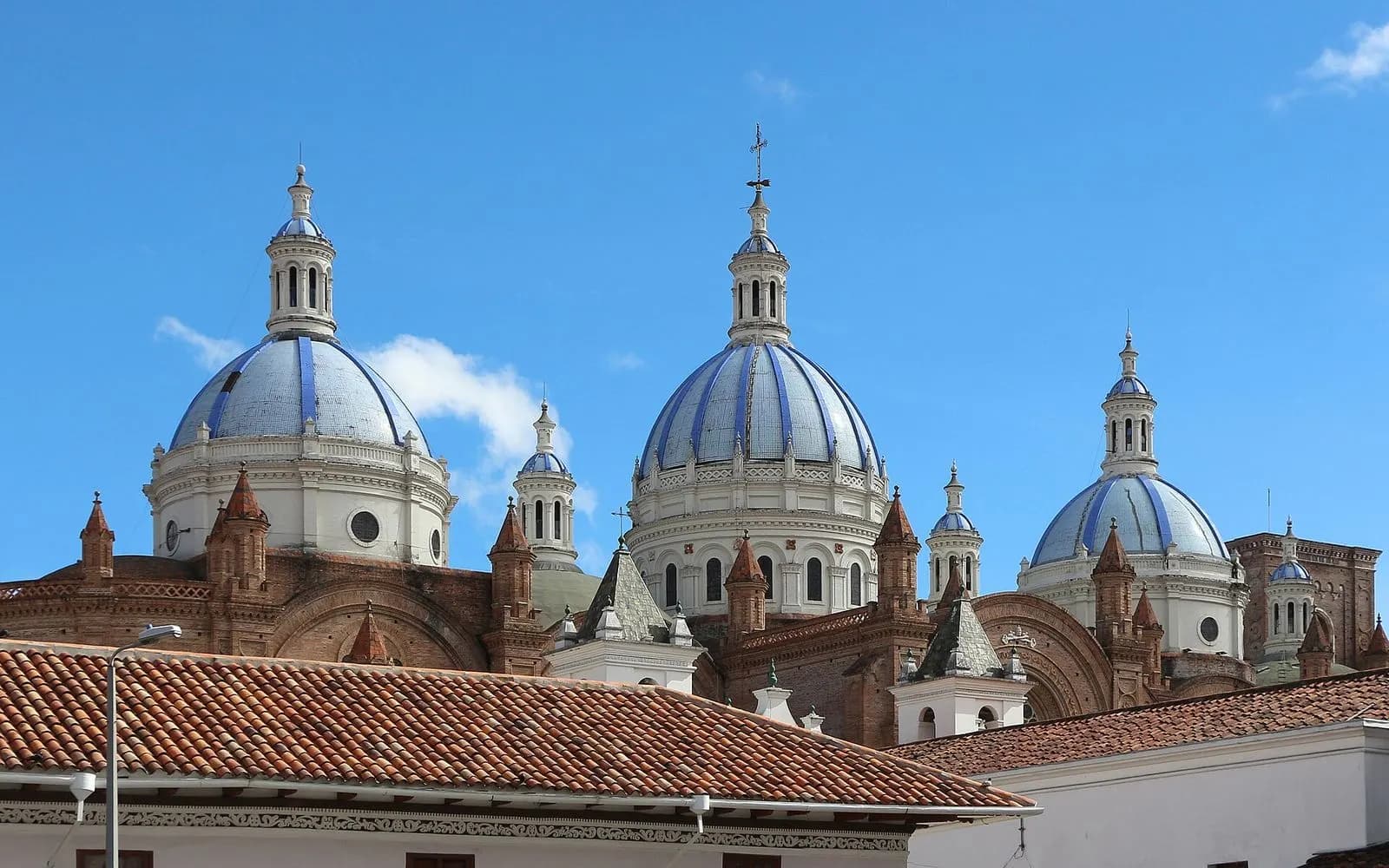 Blue and white domes of Cuenca's New Cathedral over terracotta roofs, Cuenca, Ecuador