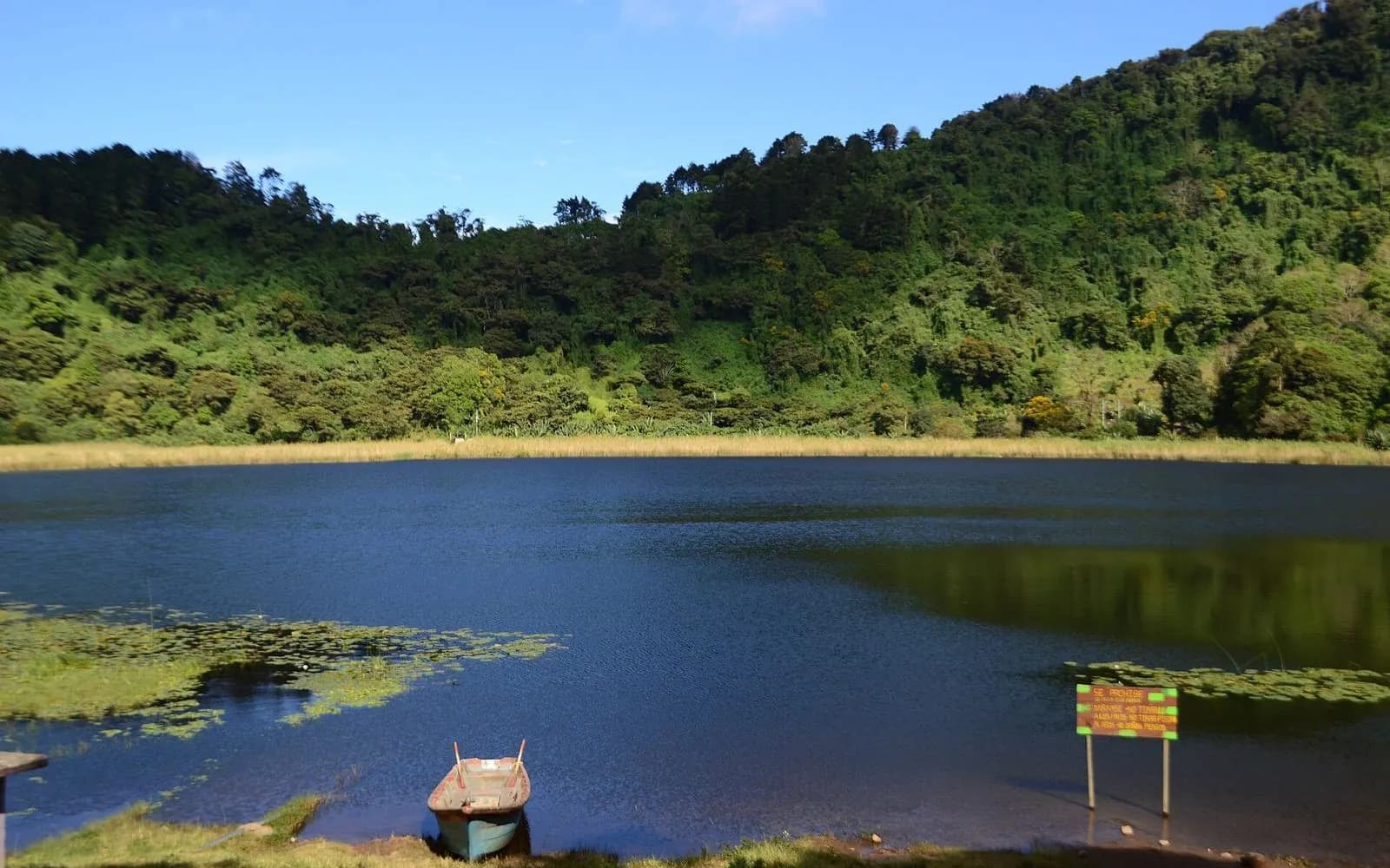 Green crater lake ringed by forested hills near Apaneca, Ruta de las Flores, El Salvador