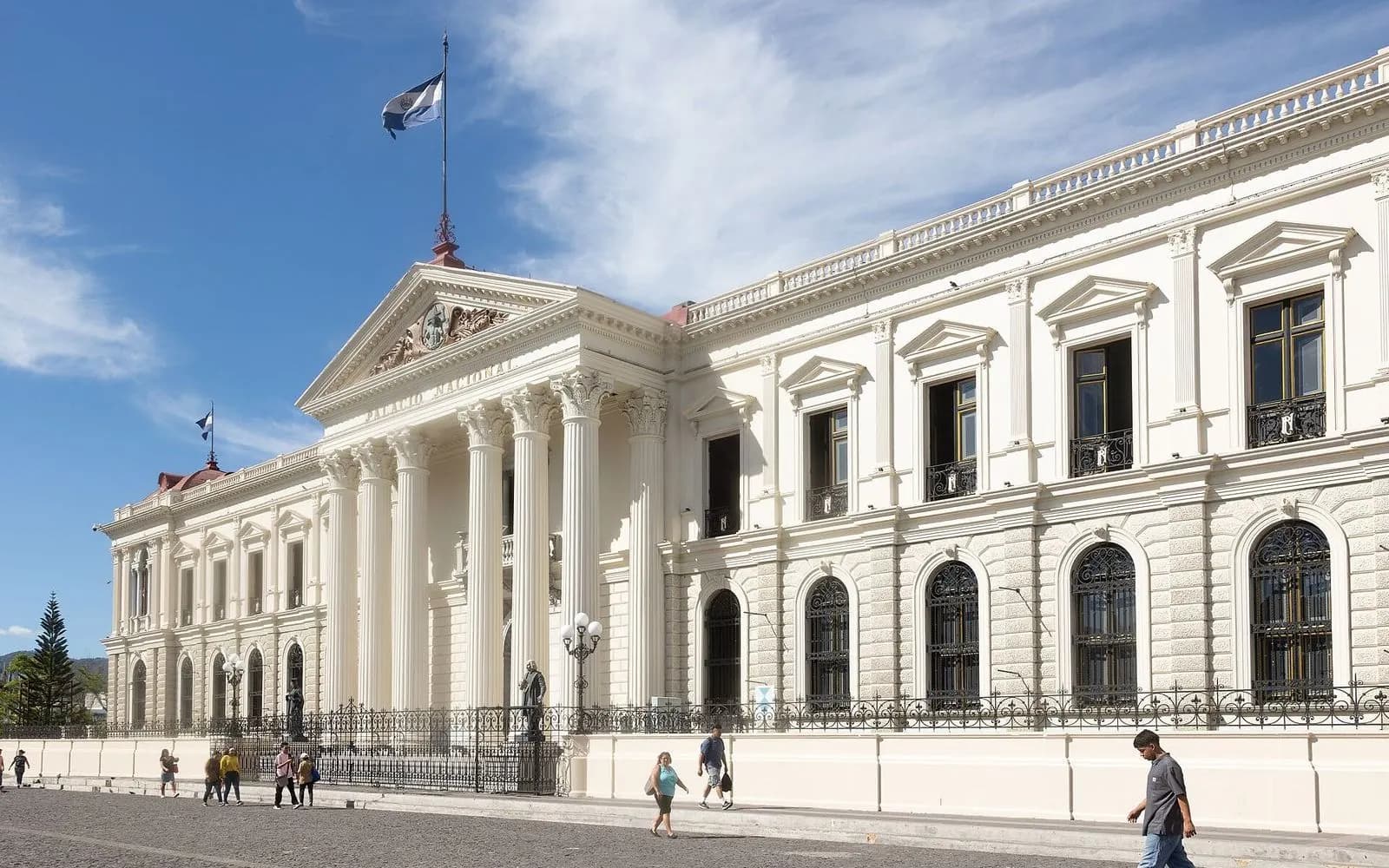 White neoclassical National Palace with columned portico under blue sky, San Salvador, El Salvador