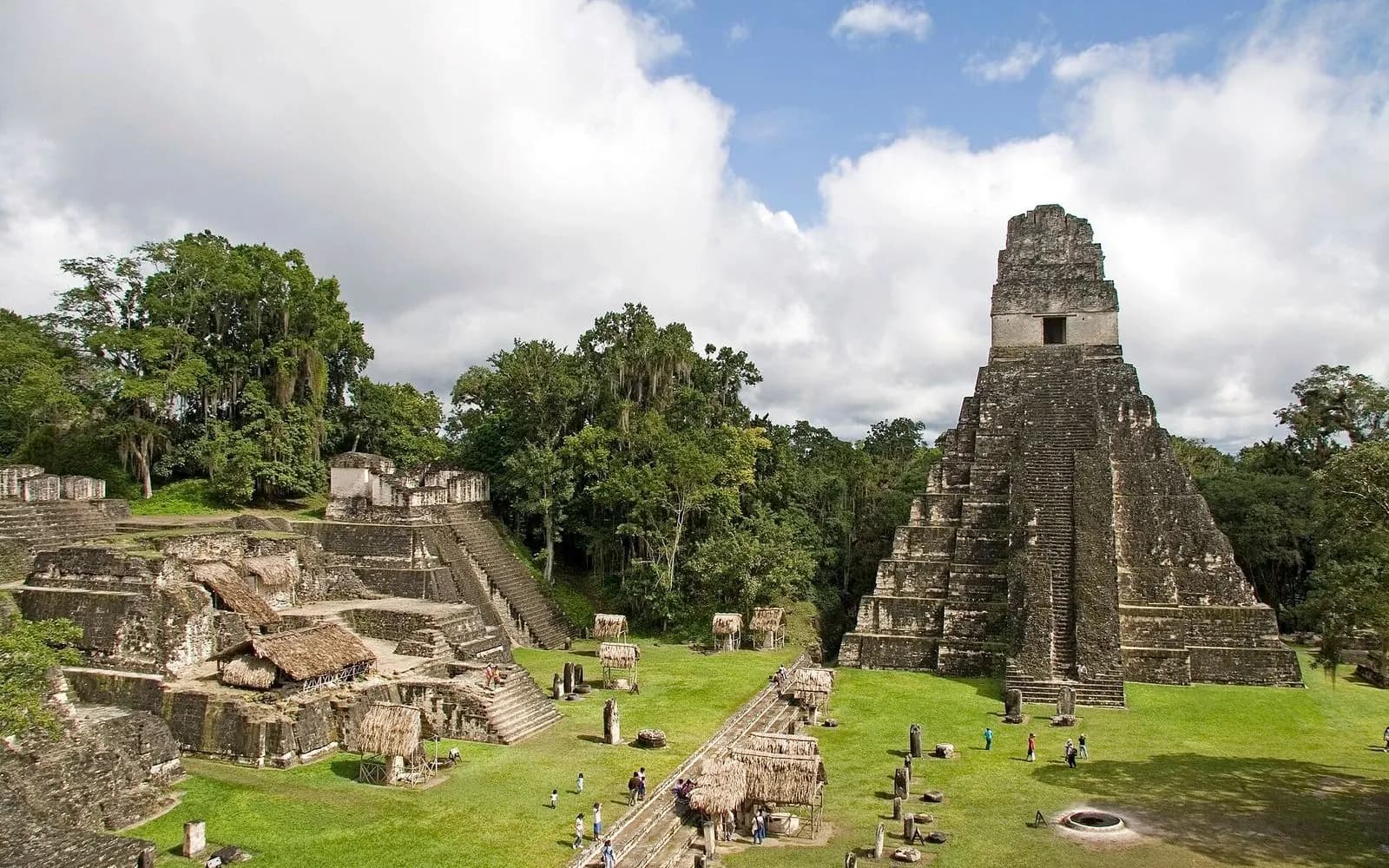 Temple I rising above the Great Plaza under a cloudy sky at Tikal, Guatemala