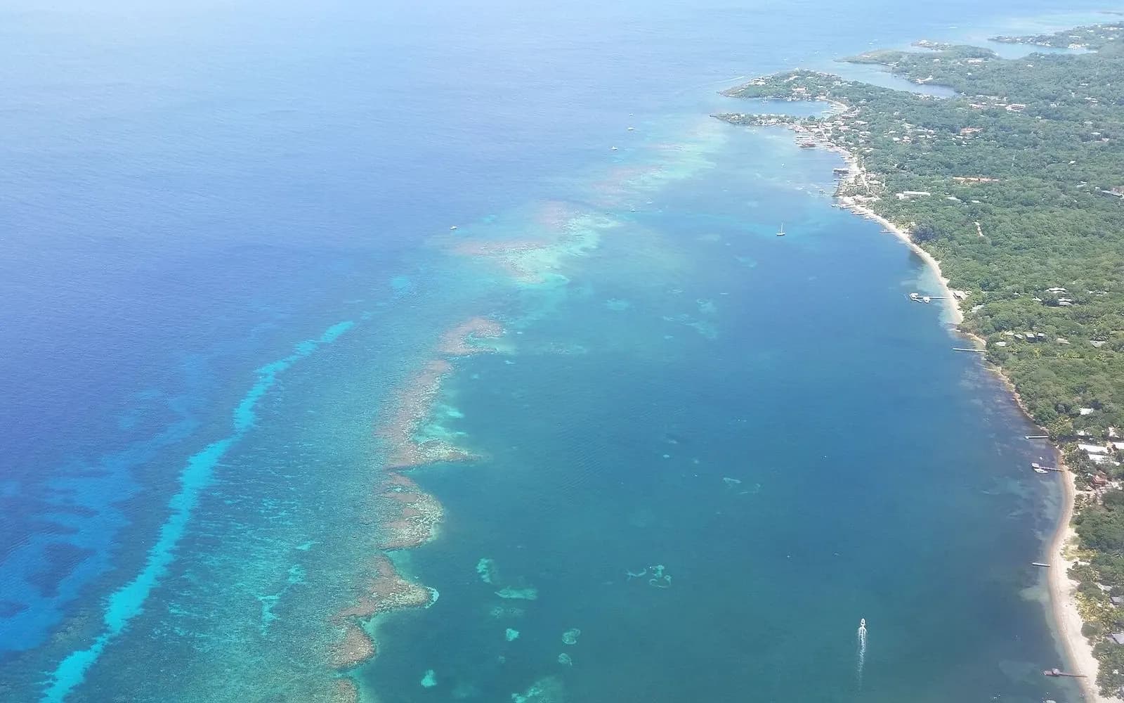Aerial view of the turquoise barrier reef along the coast of Roatán, Bay Islands, Honduras