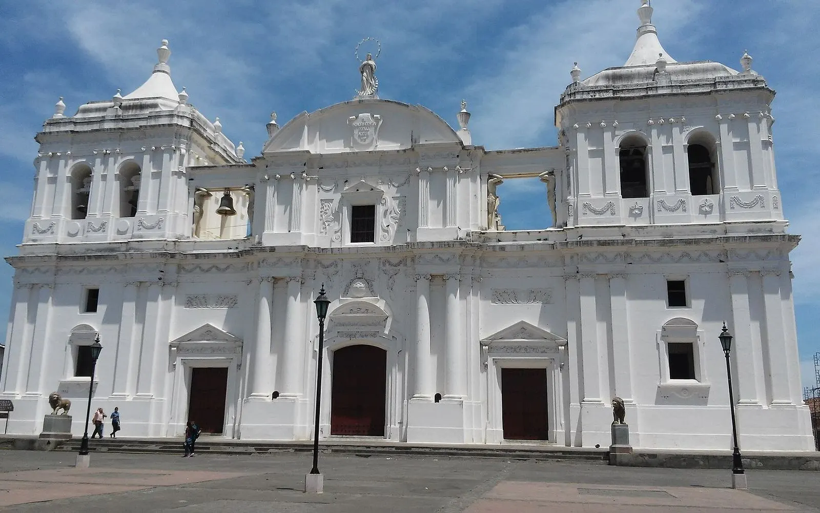 Whitewashed cathedral with domes and bell towers under a blue sky, León, Nicaragua