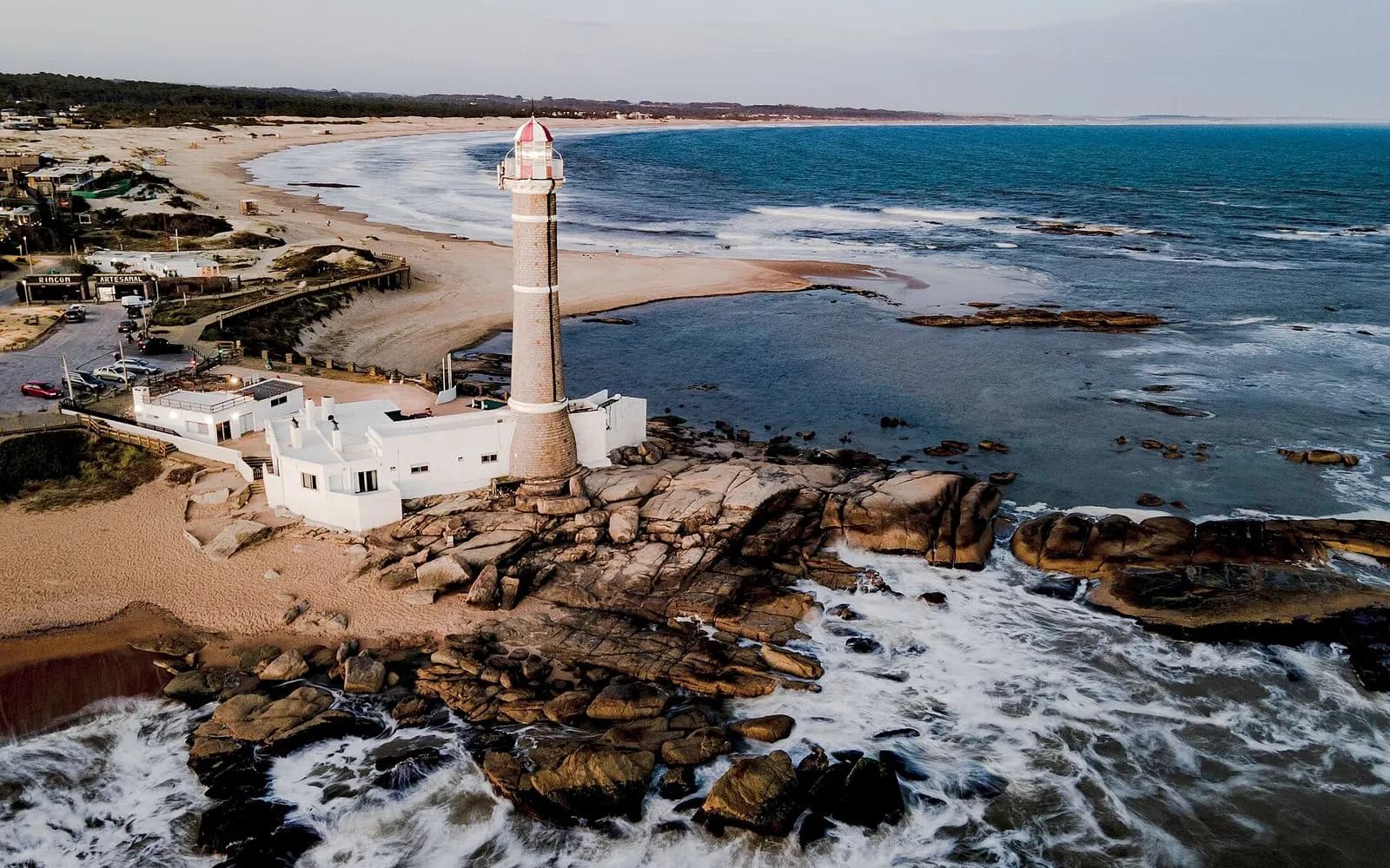 Aerial view of the José Ignacio lighthouse on a rocky point by a sandy beach, Uruguay