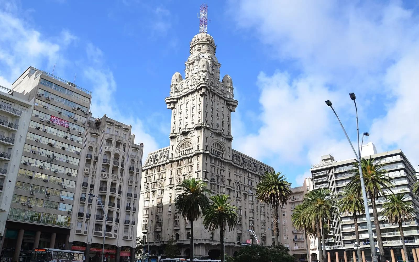 The ornate tower of Palacio Salvo above palm-lined Plaza Independencia, Montevideo, Uruguay
