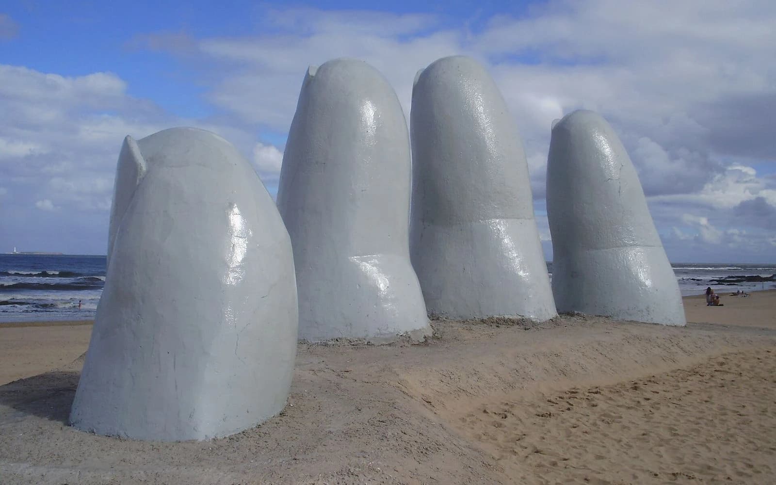 The white fingers of the Hand sculpture rising from Playa Brava sand, Punta del Este, Uruguay