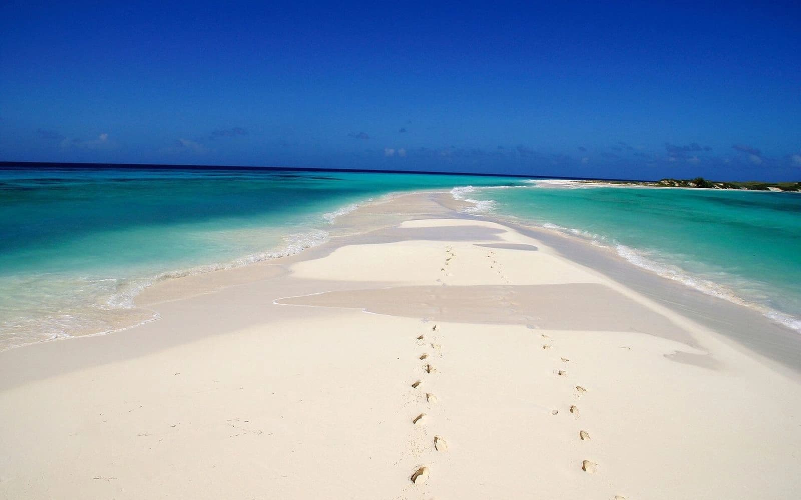 White sandbar curving into turquoise shallows under deep blue sky, Los Roques, Venezuela